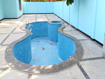 A pool technician testing water chemistry with a digital kit.