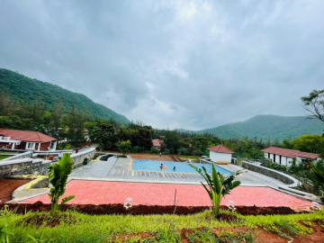 A luxury infinity pool overlooking the ocean at sunset.
