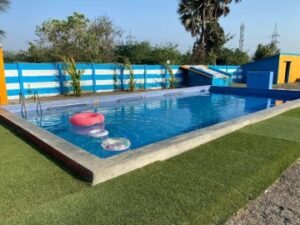 An instructor teaching a group of children how to kick in a dedicated swim academy lane.